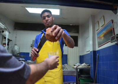 Pouring fresh coconut water in Alameda Market, Cali, Colombia. Photo  by Melissa Reichwage/CIAT.