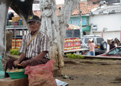 A man threshes beans in a park in Cali, Colombia. Photo by: Melissa Reichwage/CIAT.